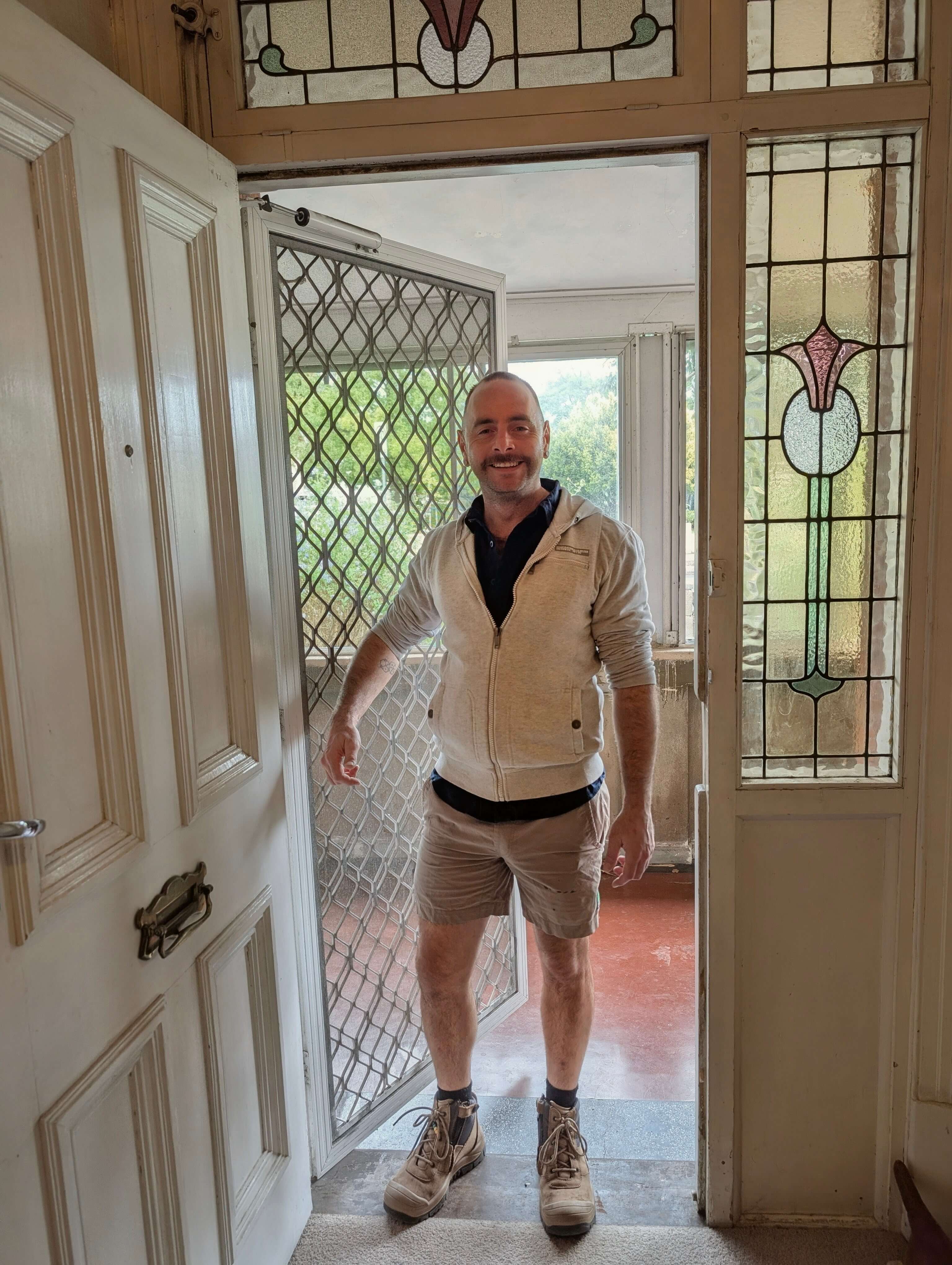 Aaron standing at his door, ready to help